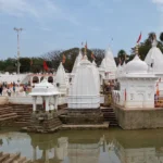 White temple complex near holy water tank