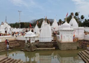 White temple complex near holy water tank