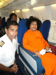 Sathya Sai Baba seated in airplane picture.