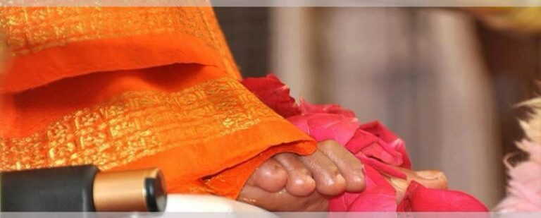 Foot adorned with petals and orange fabric