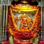 Sacred Goddess Durga idol adorned with vibrant floral garlands