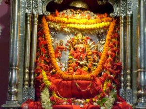 Sacred Goddess Durga idol adorned with vibrant floral garlands