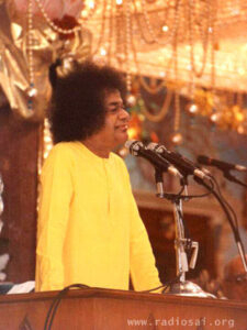 Sathya Sai Baba at the podium photo.
