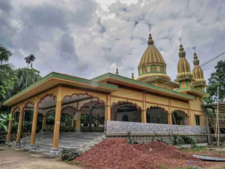 Beautiful Hindu temple surrounded by greenery under cloudy skies