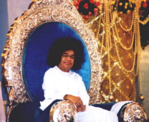 Sathya Sai Baba sitting on chair photo.