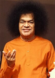 Smiling man wearing orange shirt picture.