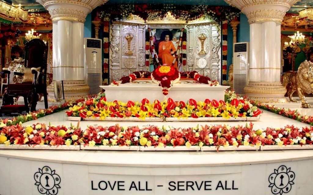 sri sathya sai baba Decorative shrine with floral arrangements image