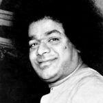 shri sathya sai baba with curly hair, seated photo