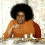 Spiritual leader seated before meal table photo