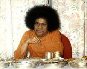 Spiritual leader seated before meal table photo