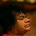 Person with curly hair, orange attire.