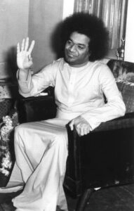 Sri Sathya Sai Baba blessing devotees seated