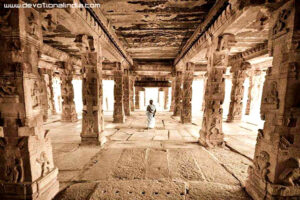 Ancient stone temple hall with devotee image