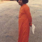 Shri Sathya Sai Baba walking outdoors