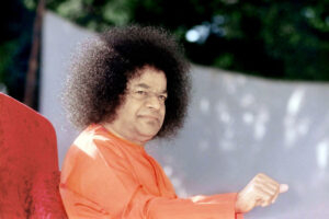 Sathya Sai Baba in orange robe picture.