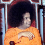 Sathya Sai Baba seated in peaceful picture.