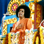 Sathya Sai Baba on floral throne picture