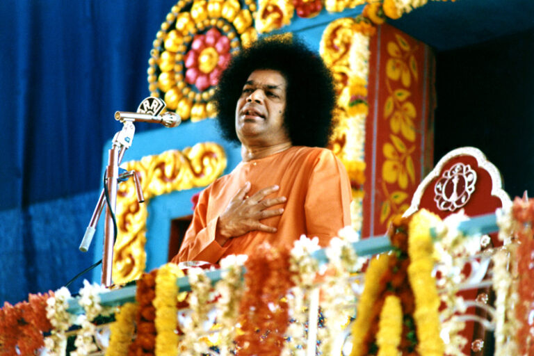 Sathya Sai Baba on floral throne picture
