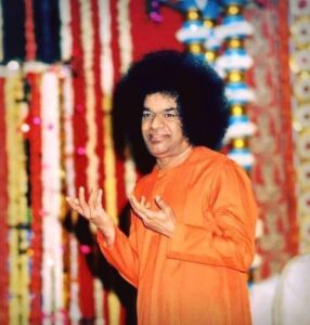 Shri Sathya Sai Baba standing indoors photo