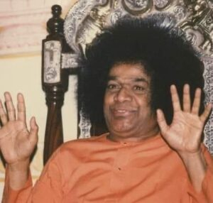 Sathya Sai Baba raising both hands photo.