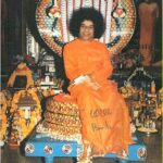 Sathya Sai Baba seated with cobra photo.