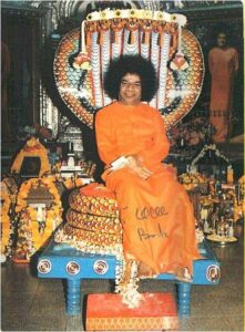 Sathya Sai Baba seated with cobra photo.