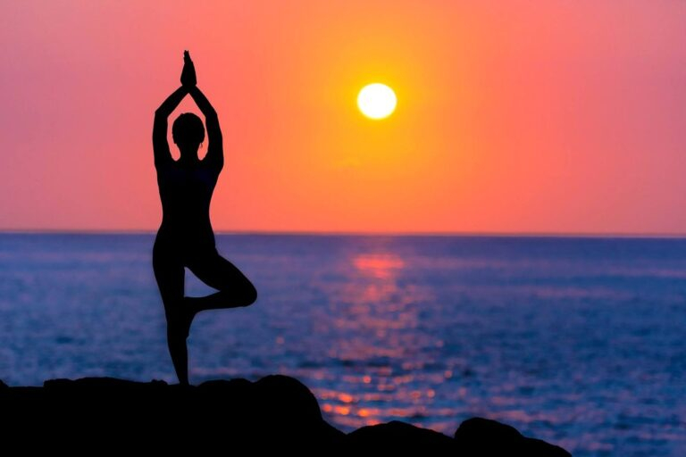 Person practicing yoga at sunrise image