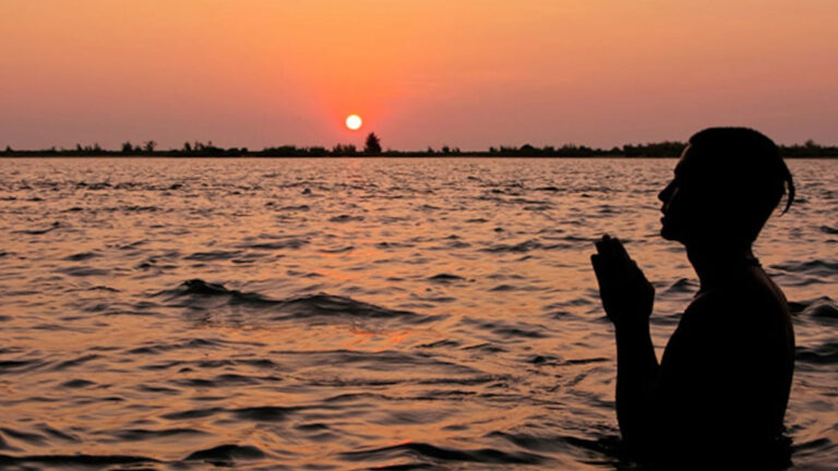 Person offering sunrise prayer image