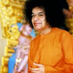 A close-up portrait of Sathya Sai Baba.
