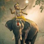 Bal Ganesha seated upon majestic elephant
