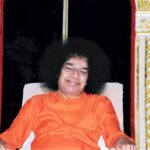 Smiling Sathya Sai Baba seated image