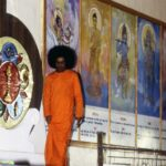 Bhagwan Shri Sathya Sai Baba beside divine murals image