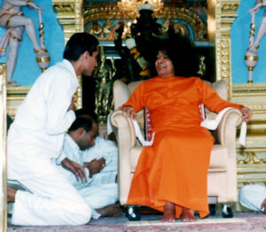 Sathya Sai Baba seated in a chair.