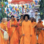 Bhagwan Shri Sathya Sai Baba walking with devotees picture