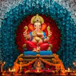 Lord Ganesha idol with colorful floral backdrop