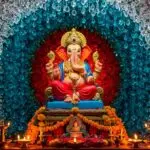 Lord Ganesha idol with colorful floral backdrop