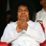 Sri Sathya Sai Baba seated with folded hands, Veda Pushpanjali Part Second