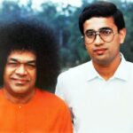 Sathya Sai Baba posing with a devotee.