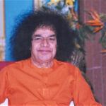 Shri Sathya Sai Baba smiling while seated picture