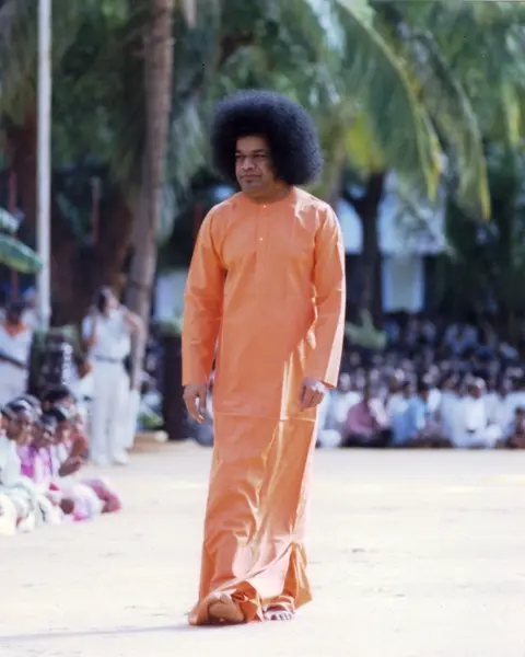 Shri Sathya Sai Baba walking outdoors picture