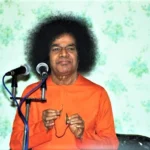 Shri Sathya Sai Baba speaking at microphone picture, Upanishads