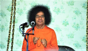 Shri Sathya Sai Baba speaking at microphone picture, Upanishads