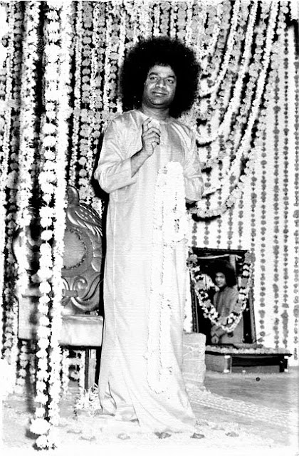 Shri Sathya Sai Baba standing on decorated stage picture