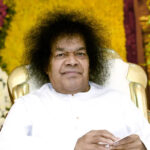 Bhagawan Sri Sathya Sai Baba seated with peaceful divine smile, Miracle Across Globe