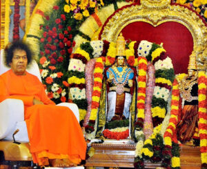 Shri Sathya Sai Baba beside Shiva Parvati Kalyanam idols