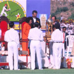 Sathya Sai Baba presenting a cricket trophy.