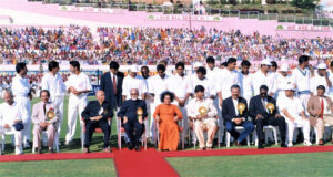 Sathya Sai Baba sitting with cricket players.
