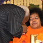 Shri Sathya Sai Baba blessing devotee picture