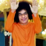 Sri Sathya Sai Baba blessing devotees with raised hands