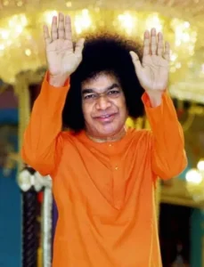 Sri Sathya Sai Baba blessing devotees with raised hands